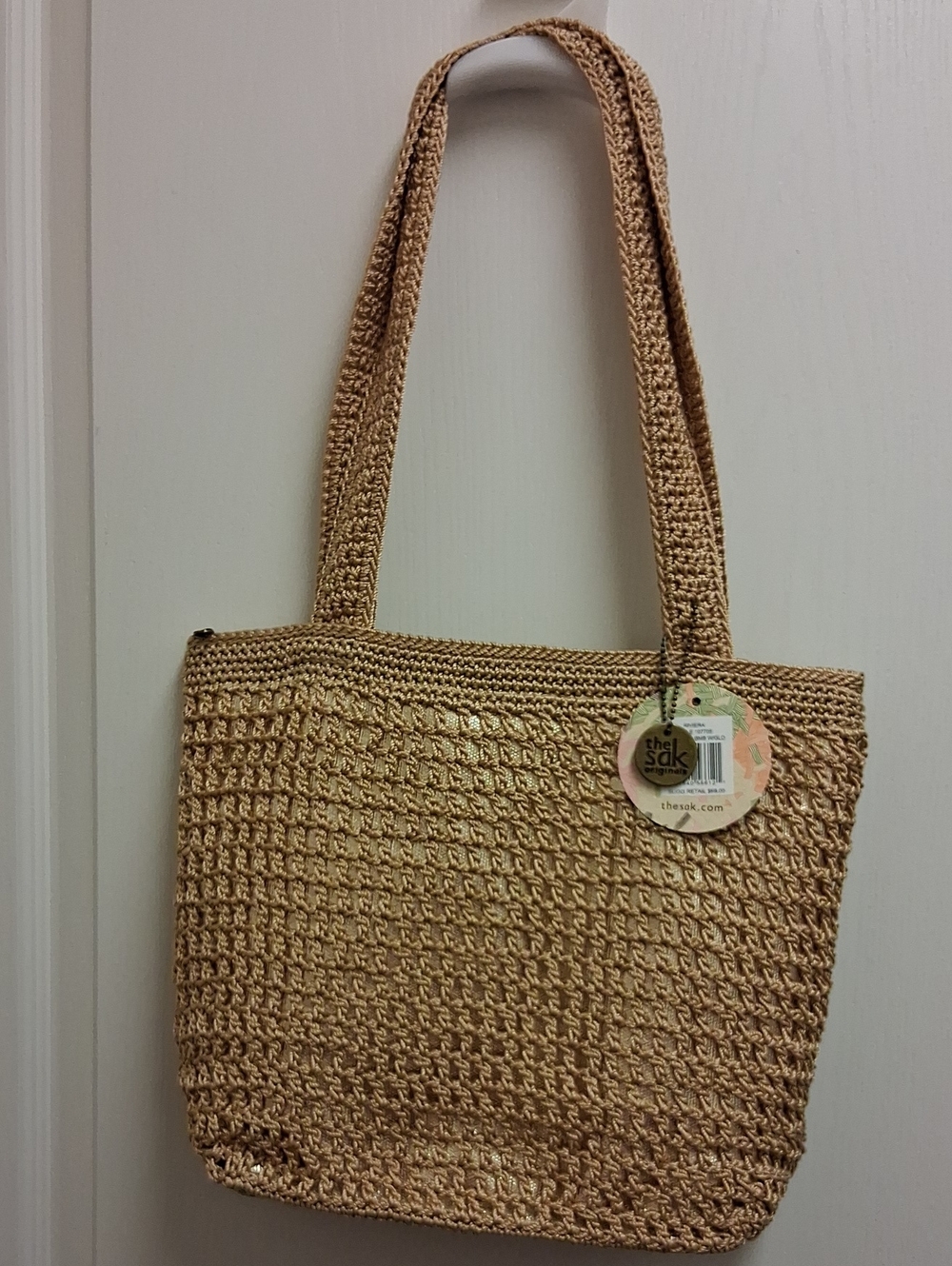 The Sak Woven Tote in Natural Tan With Gold Lame' Background